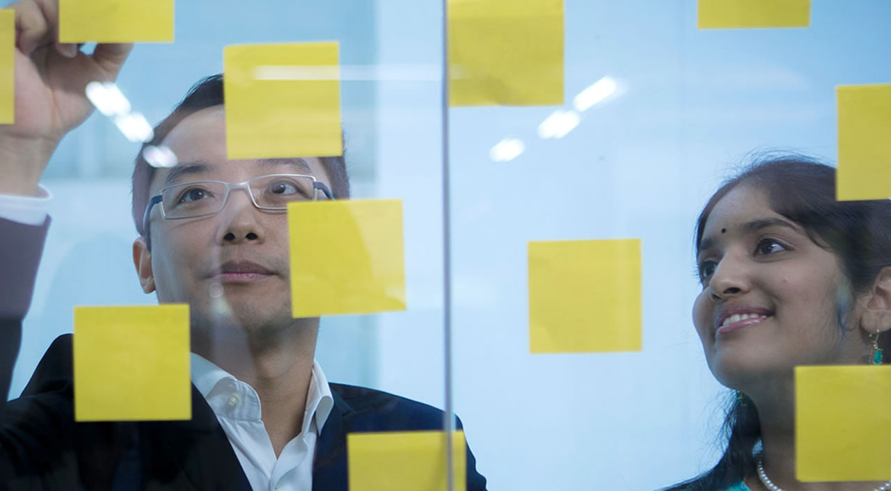 Man showing post-its with a student